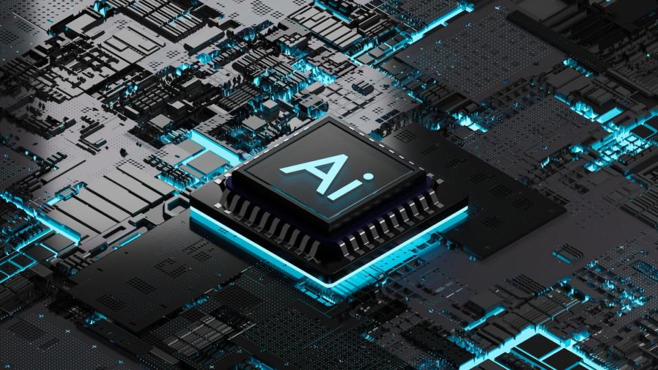 An AI chip on a black and teal motherboard.