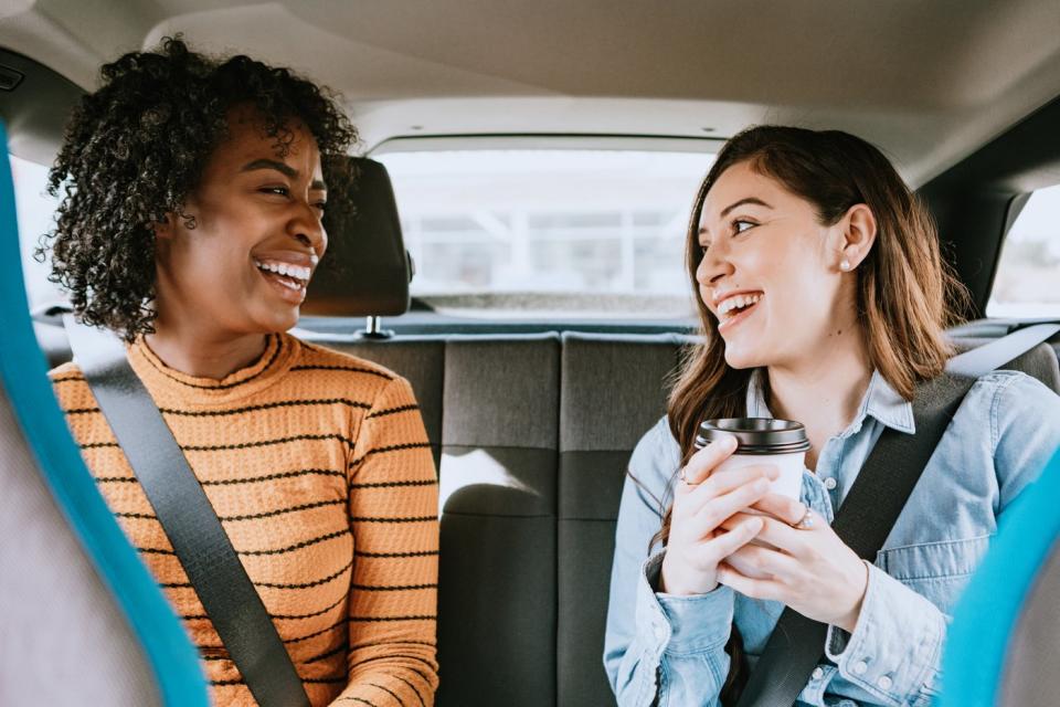 Two women in the back of a ridesharing car.