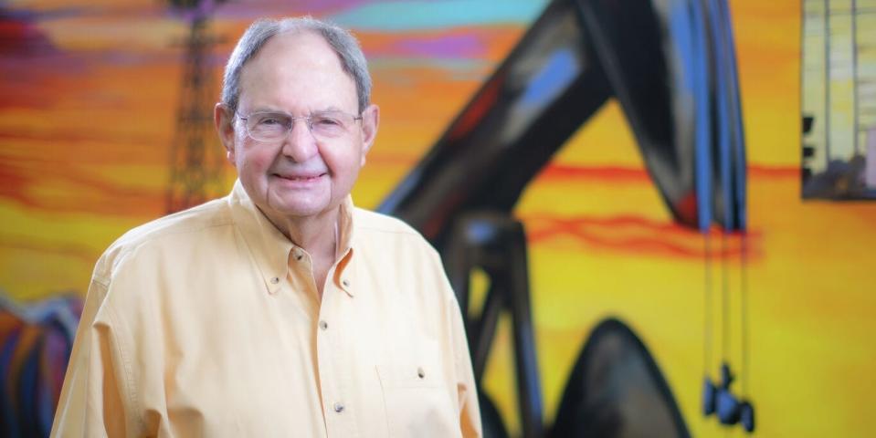 Autry Stephens smiling in front of a colorful mural.