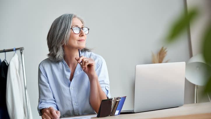 A small business owner looks over her retirement savings and thinks about the future.