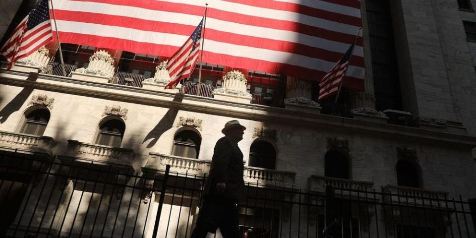 Photo of Wall Street with huge US flags