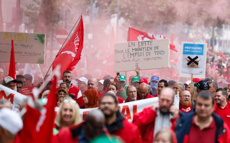 Protesters march during a demonstration over the potential closure of a Volkswagen factory in Brussels, Belgium