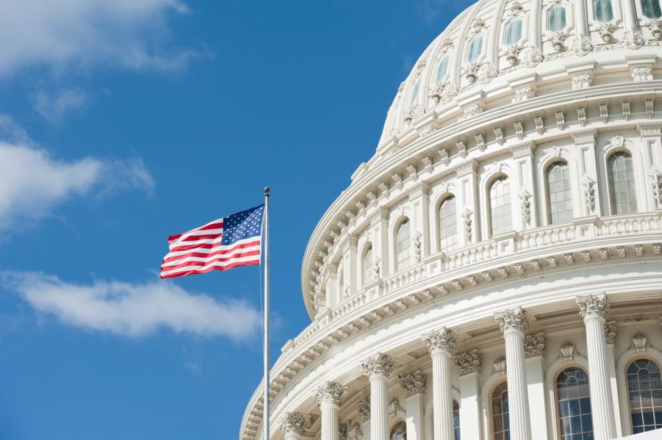 The Capitol dome in Washington with an American flag.