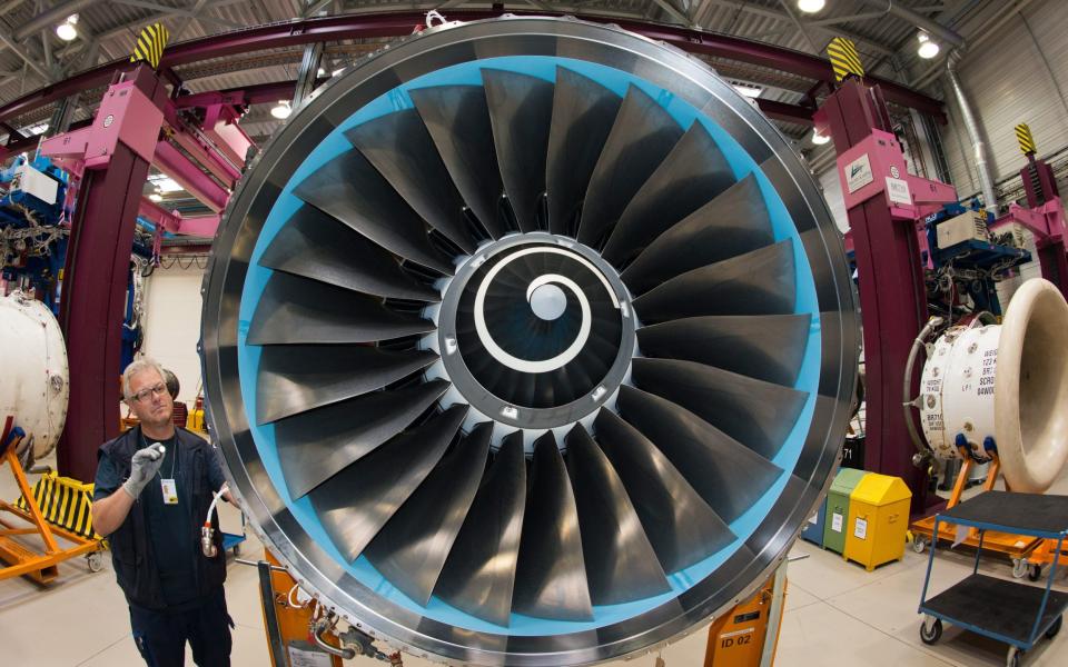 A mechanic at Rolls-Royce working on a plane engine in the company's factory in Dahlewitz, Germany