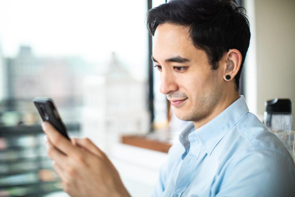 An investor looks at something on a phone.