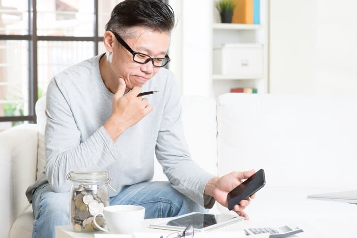 A man adjusting his retirement savings goals after researching the average savings for his age group.