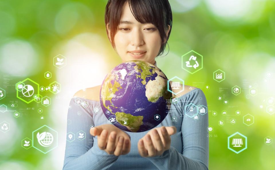 Woman holds globe in her hands. 