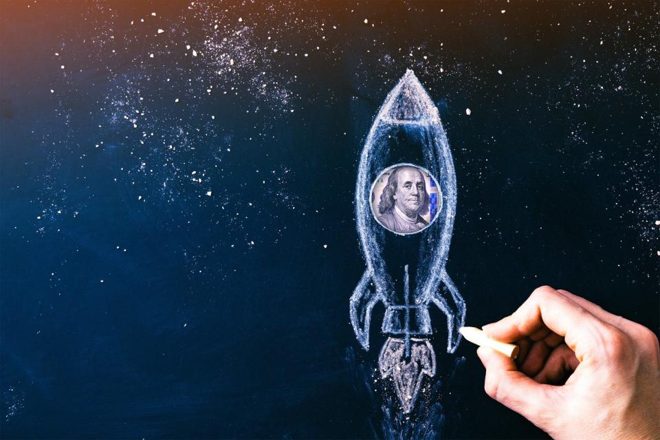 A drawing of a rocket with a picture of Ben Franklin from a $100 bill in the rocket.