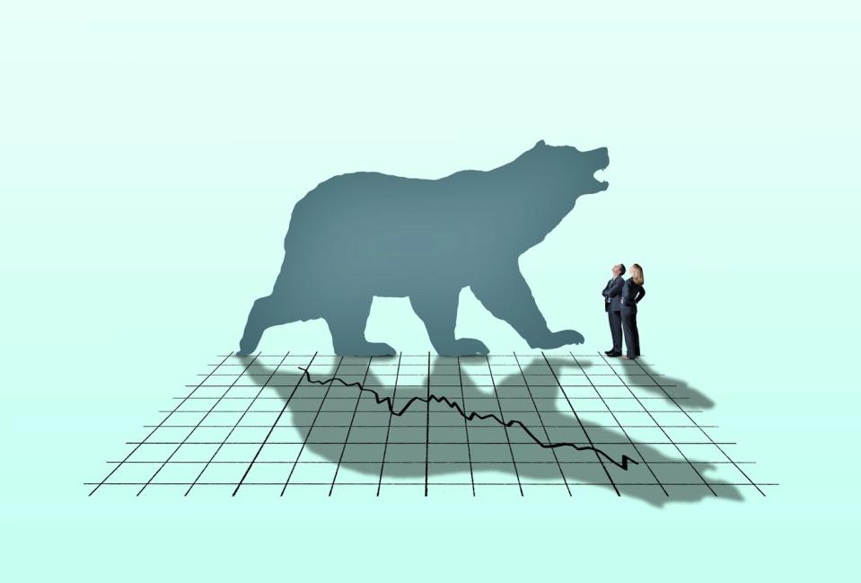 Bear silhouette against a stock market chart.