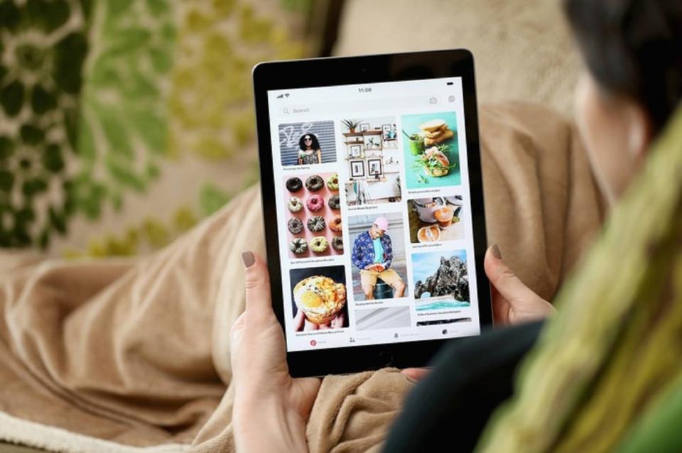 A person perusing a pinned board on Pinterest using a tablet.