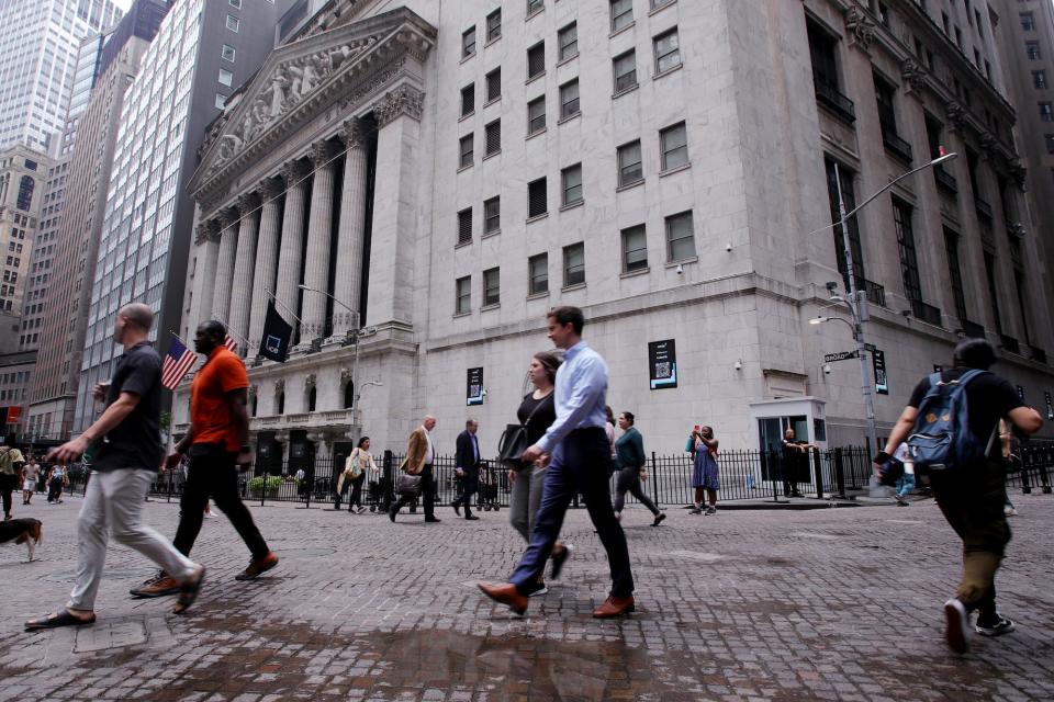 People walk near the New York Stock Exchange