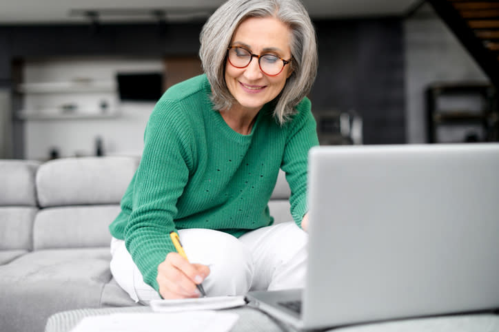 A woman drafts her retirement budget, allocating money to her living expenses and discretionary spending.