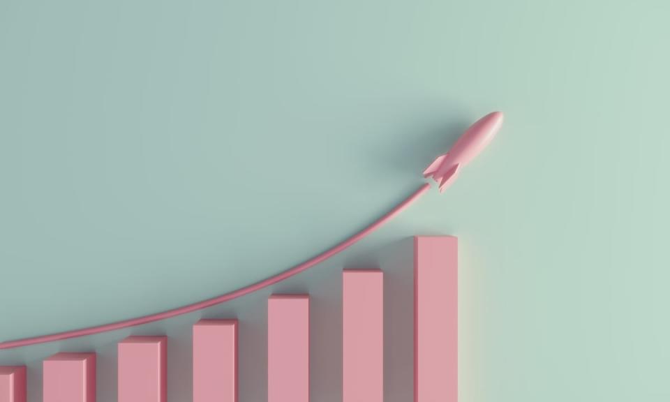 A pink rocket ship flying above a pink rising bar graph.