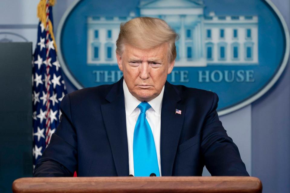 President Trump addressing reporters behind the White House podium.