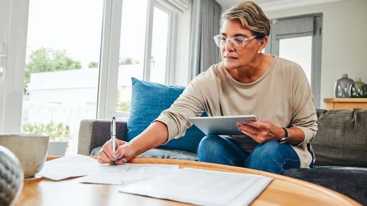 A woman looks over her retirement account balances and plans out her withdrawal strategy.