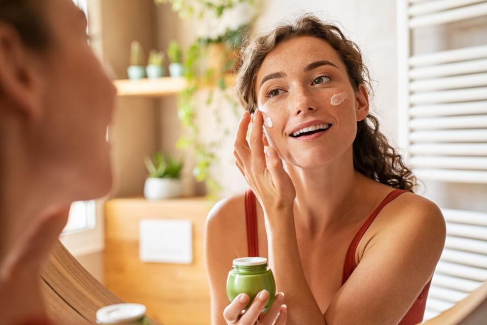 A person putting a facial ointment on.